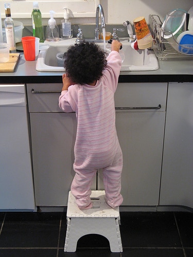 toddler washing dish