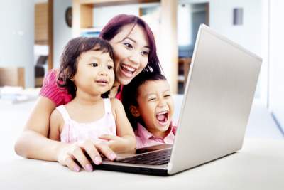 mom on computer with kids