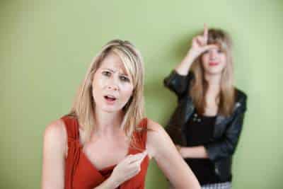 annoyed mom with woman saying loser