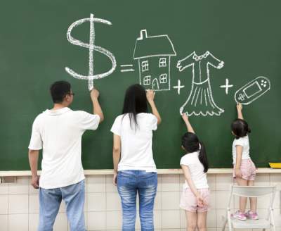 parents writing about money on chalkboard