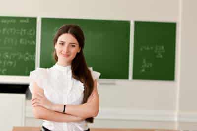 teacher in front of chalk board