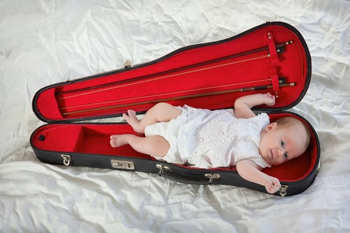 baby in violin case