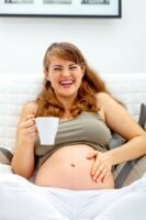 preggo laughing with coffee cup med size optimized__1407331065_108.91.141.188