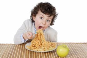 hungry boy eating spaghetti