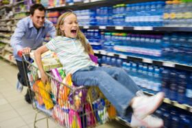 girl pushed on shopping cart