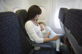 mom-with-sleeping-baby-on-airplane