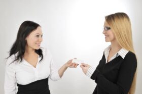 women exchanging business cards