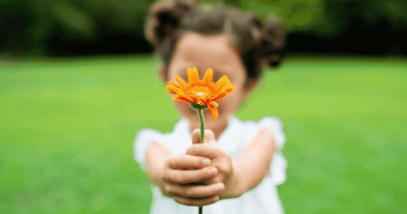 child holding flower